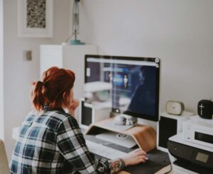 Woman at a desk browsing the internet.